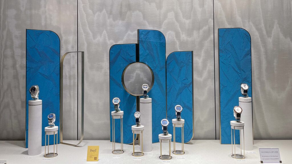 Visual comparison of permanent MDF retail display vs. temporary cardboard fixture in department store