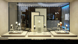 High-end skincare retail display with brushed brass, suede surface, and integrated LED lighting