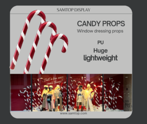 Candy-themed holiday window display with oversized candy cane and stacked boxes