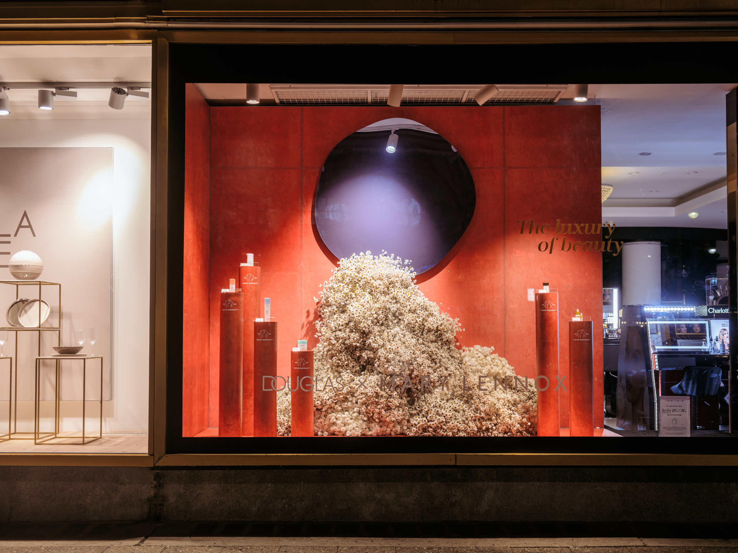 Faux silk flower display in luxury retail window