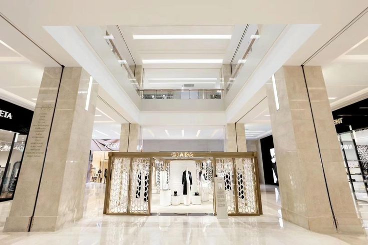 Watch display case featuring gold metal frames with transparent glass, showcasing luxury timepieces in a minimalist yet sophisticated retail environment.