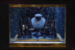 Luxury fashion window display with lavender paper arches and gradient backdrop