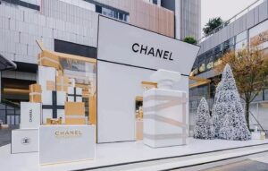 Oversized red gift box and ribbon in luxury retail window for Christmas