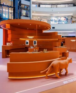 Monochrome red tunnel display in luxury retail showcasing sculptural
