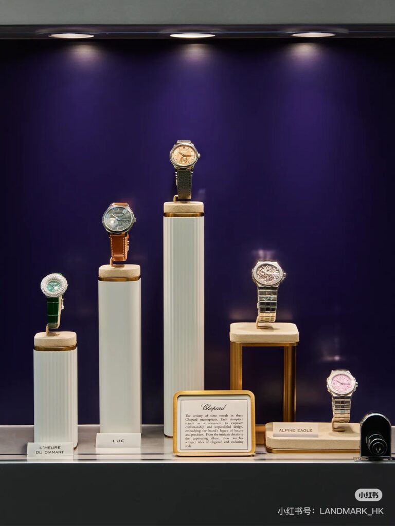 Premium luxury watch display with matte black podium and frosted clock engraving in flagship window display