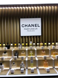 LUMIERA Mother's Day perfume display with paper peonies and mirror signage