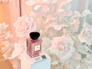 Mother’s Day display with pink paper floral arch and heart wall