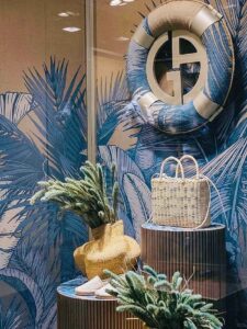 UV-painted paper surfboard with tropical coconut tree props for fashion window”