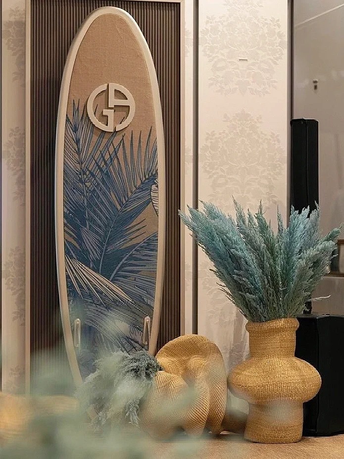 UV-painted paper surfboard with tropical coconut tree props for fashion window