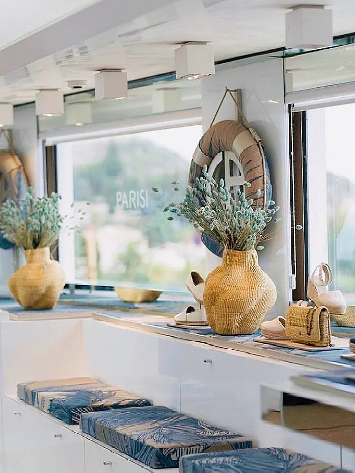 UV-painted paper surfboard with tropical coconut tree props for fashion window”