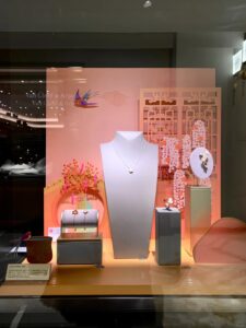 Custom jewelry display with suede base, foil logo, and LED spotlight