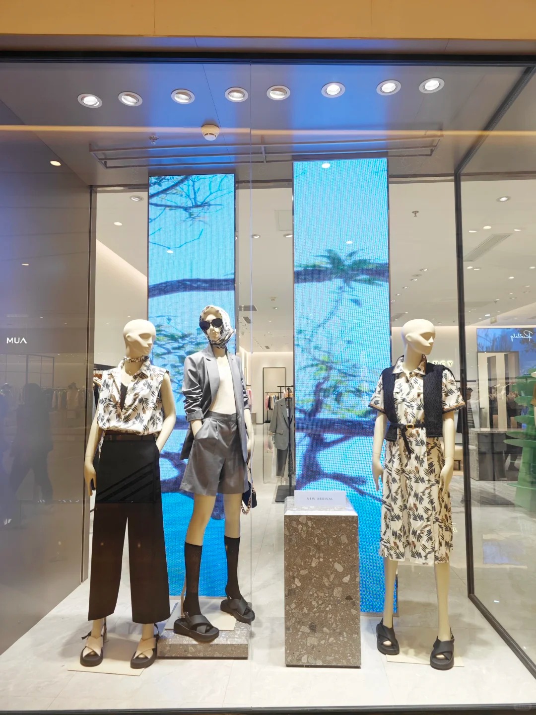 Fashion retail storefront with illuminated window displays