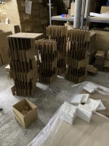 Sustainable packaging setup using corrugated cardboard structures and recyclable cushioning materials for retail display kits