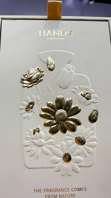 Premium packaging box featuring embossed floral design with gold foil accents for a high-end tactile finish