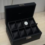 A custom luxury watch box featuring premium textured leather and a clear display window, representing high-end bespoke packaging solutions.