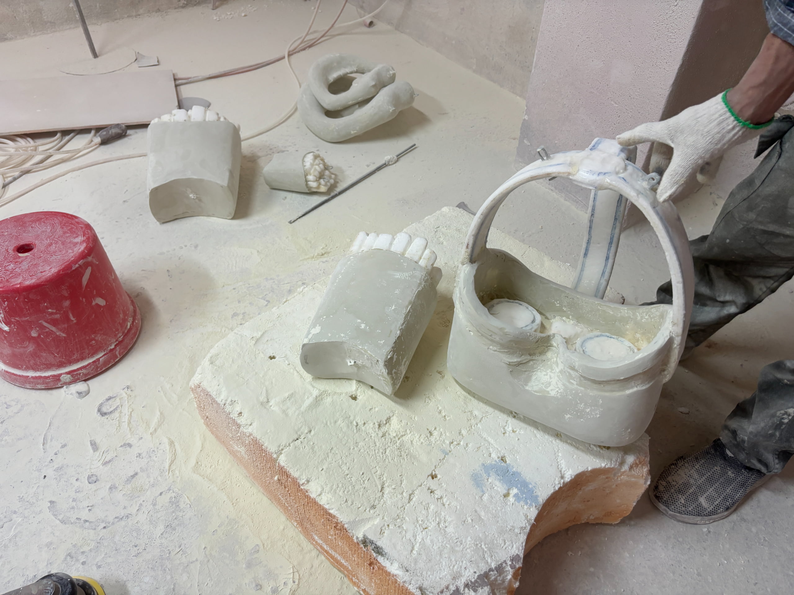 Craftsman working on resin molds for custom Christmas ornament props at Samtop factory, showing the early stage of character figure fabrication