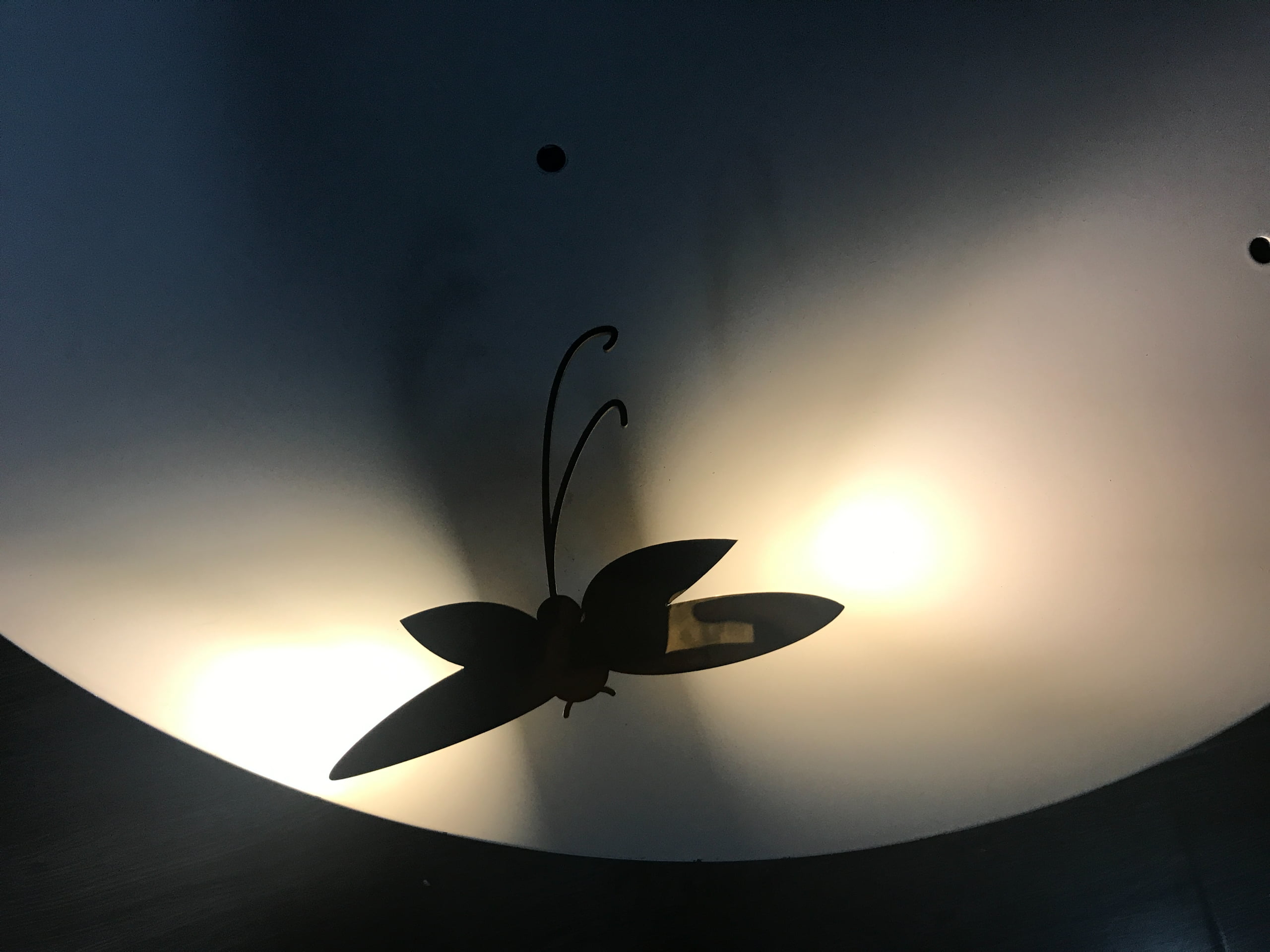 Close-up of a metal dragonfly display prop with concealed LED lighting