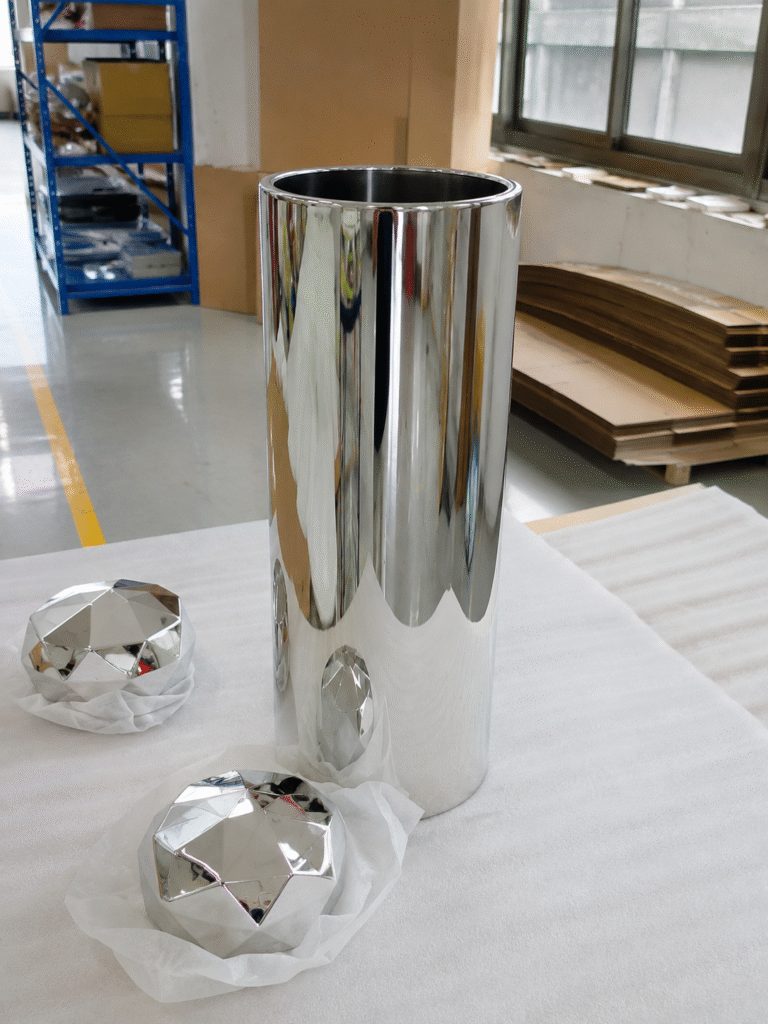 Reflective cylindrical display body with separate faceted cap components in the workshop