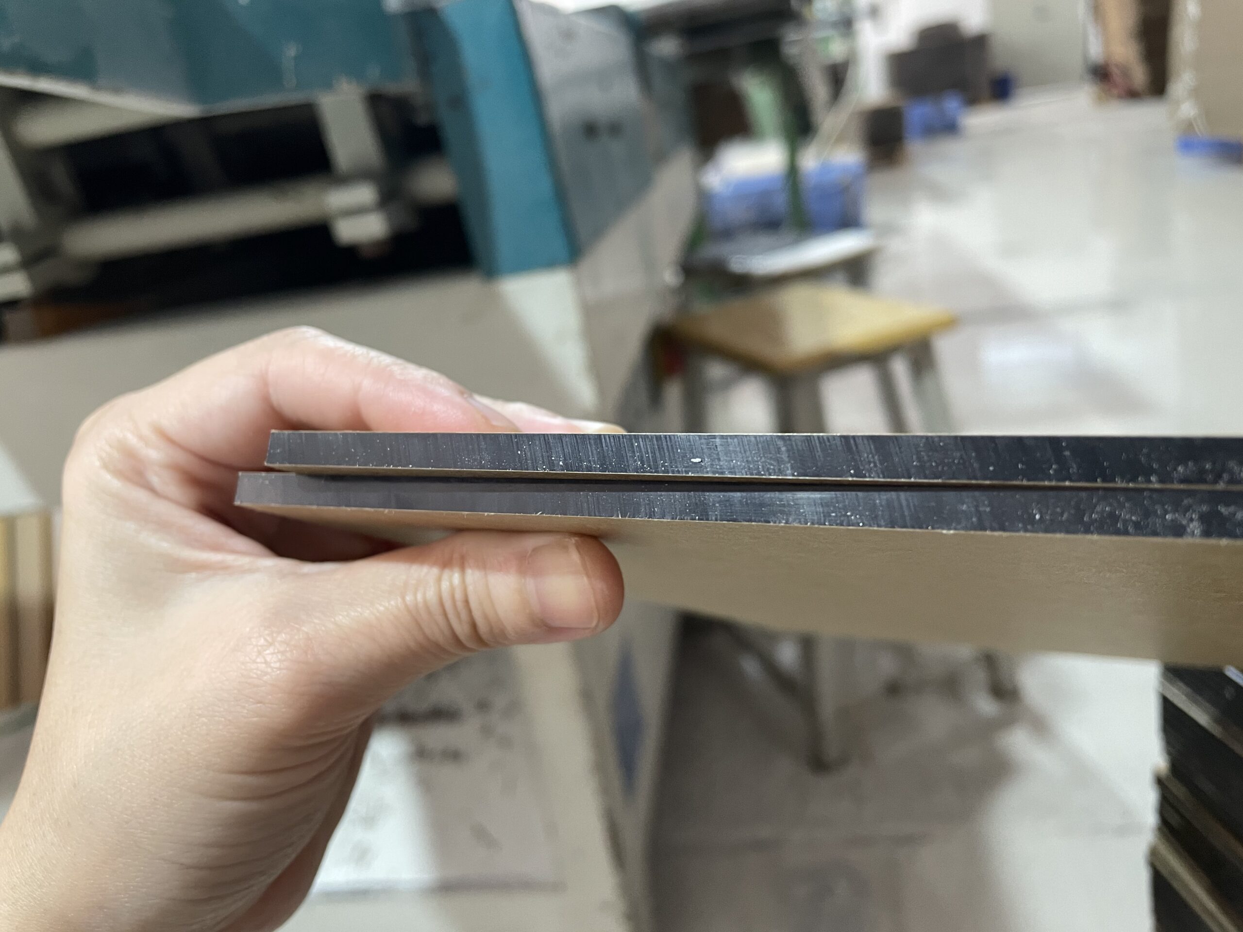 Close-up comparison of black acrylic sheet thicknesses for retail display production