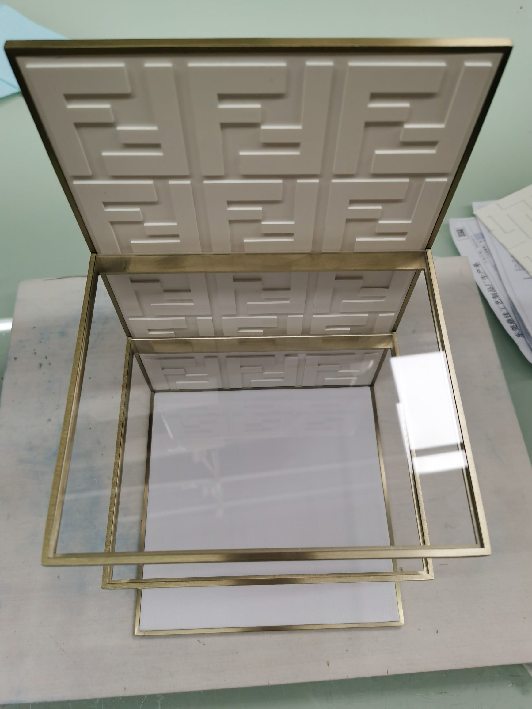 Physical retail display prototype during assembly and inspection -- checking materials, joints and product fit