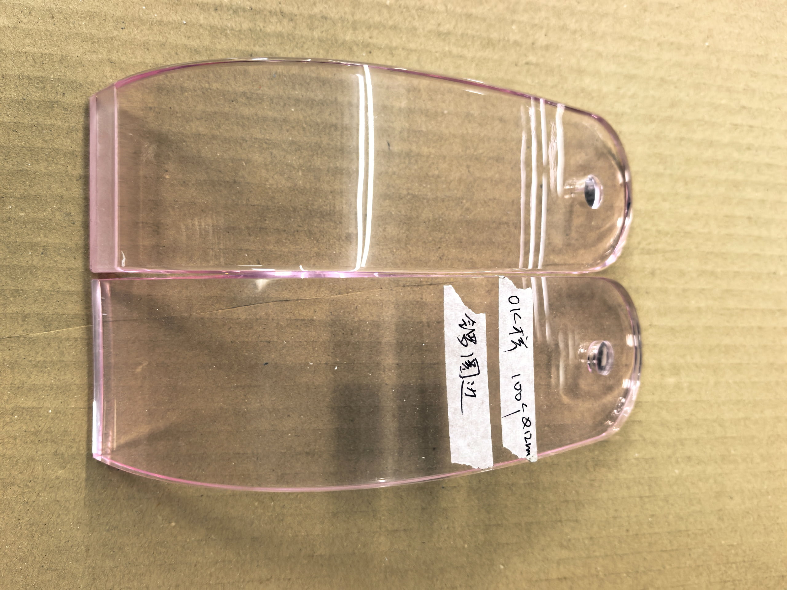Physical acrylic component during fabrication -- showing real material properties, bends and edges that differ from digital rendering